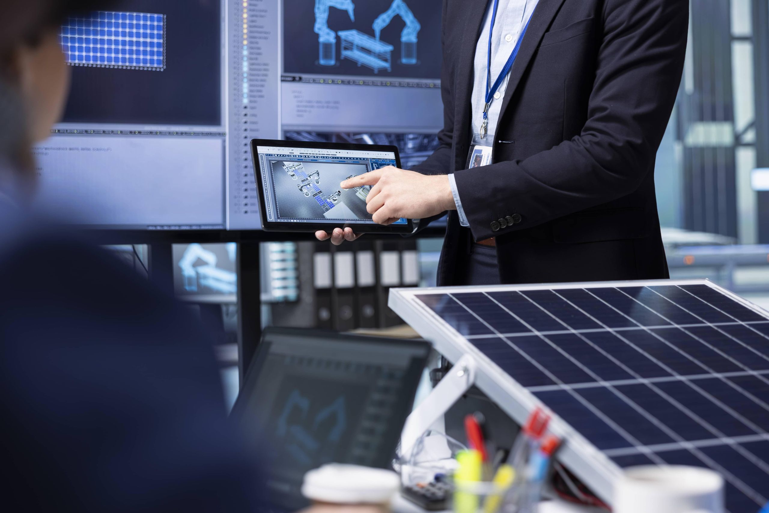 investors-examine-solar-panel-surface-using-tablet-discussing-design-efficiency-1 image Guardian Home Pro roof and solar system monitoring NC