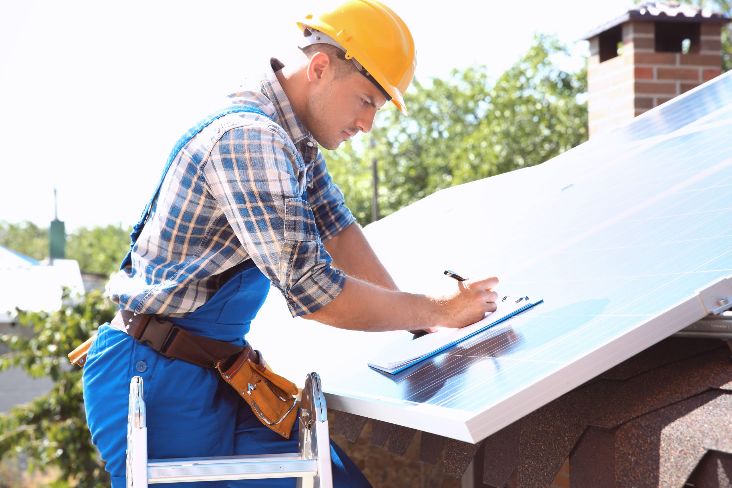 worker-installing-solar-panels-outdoors-1 image Roof inspection by Guardian Home Pro in North Carolina