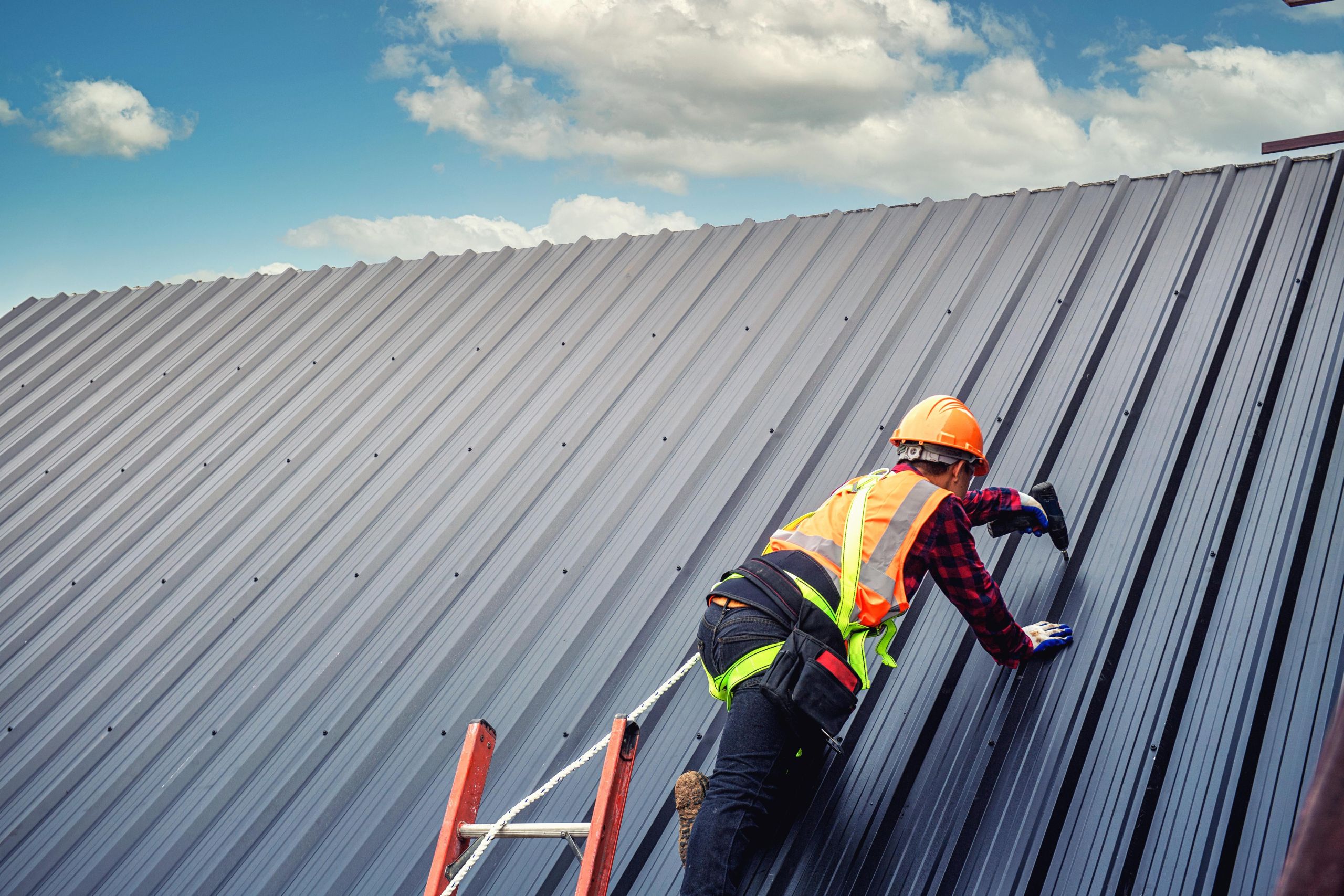 worker-man-building-tradesman-roof-house-with-safety-helmet-2 image Roofing and solar panel services in Asheville NC